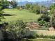 A spacious yard featuring a garden, lawn, and views of the mountains in the distance, enclosed by a fence at 1069 Crestmoor Dr, Boulder, CO 80303