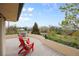 Cozy balcony with red Adirondack chairs and panoramic views of the surrounding landscape at 1069 Crestmoor Dr, Boulder, CO 80303