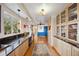 A bar area has hardwood floors, cabinetry and a granite countertop at 1069 Crestmoor Dr, Boulder, CO 80303