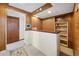 Basement bar with white brick, wood accents, and shelving ready for entertaining at 1069 Crestmoor Dr, Boulder, CO 80303