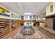 Finished basement featuring vinyl flooring, a brick fireplace, and a built in wine rack at 1069 Crestmoor Dr, Boulder, CO 80303