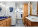 Bathroom featuring blue accents, a glass enclosed shower, and built in wooden cabinet for storage at 1069 Crestmoor Dr, Boulder, CO 80303