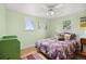 Bedroom boasts verdant walls, light wood flooring, bright windows, and a decorative comforter at 1069 Crestmoor Dr, Boulder, CO 80303