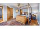 Cozy bedroom with a four-poster bed, hardwood floors, and decorative touches at 1069 Crestmoor Dr, Boulder, CO 80303