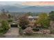 Charming home with a large front yard, lush landscaping, garden area, solar panels, and mountain views at 1069 Crestmoor Dr, Boulder, CO 80303