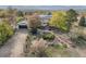 Aerial view of a home with well-manicured landscaping, mature trees, and an inviting outdoor patio space at 1069 Crestmoor Dr, Boulder, CO 80303