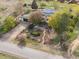 Aerial view of a home with well-manicured landscaping, mature trees, and an inviting outdoor patio space at 1069 Crestmoor Dr, Boulder, CO 80303