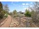 Spacious garden featuring raised garden beds with access paths and a gravel pathway at 1069 Crestmoor Dr, Boulder, CO 80303