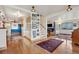 Hallway with wood floors, decor, stairs and an open archway into the living room at 1069 Crestmoor Dr, Boulder, CO 80303
