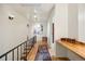 Hallway with hardwood floors, rail and natural light at 1069 Crestmoor Dr, Boulder, CO 80303