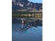 Scenic view of a person kayaking on a serene lake with mountains in the backdrop at 1069 Crestmoor Dr, Boulder, CO 80303