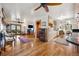 Living room with hardwood floors and views to the patio, fireplace and kitchen at 1069 Crestmoor Dr, Boulder, CO 80303
