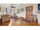 Cozy living room with hardwood floors, shutters, and a stained glass front door at 1069 Crestmoor Dr, Boulder, CO 80303