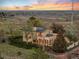 Aerial view of back of the home featuring large patio, solar panels, and surrounding open land at 1069 Crestmoor Dr, Boulder, CO 80303