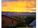 Home with solar panels that offers a stunning mountain sunset vista in the distance at 1069 Crestmoor Dr, Boulder, CO 80303