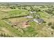 Aerial view of the property showing the land, outbuildings, and surrounding landscape at 8236 S Ireland Way, Aurora, CO 80016