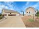 Backyard featuring a large driveway, basketball court, and multiple outbuildings for storage or hobbies at 8236 S Ireland Way, Aurora, CO 80016