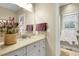 Bright bathroom with a white vanity, neutral walls, and a decorative floral arrangement at 8236 S Ireland Way, Aurora, CO 80016