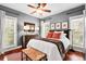Bedroom with a cozy bed, ample natural light, and hardwood floors at 8236 S Ireland Way, Aurora, CO 80016