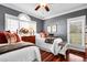 Charming bedroom featuring twin beds, wood floors, and stylish decor at 8236 S Ireland Way, Aurora, CO 80016