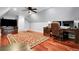 Versatile bonus room with a cozy fireplace, hardwood floors, and a desk at 8236 S Ireland Way, Aurora, CO 80016