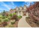Charming two-story home with brick accents, manicured landscaping, and inviting entrance at 8236 S Ireland Way, Aurora, CO 80016