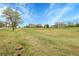 Expansive grassy yard showcasing multiple homes under a bright blue sky at 8236 S Ireland Way, Aurora, CO 80016