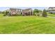 Expansive front yard with charming two-story home and lush landscaping at 8236 S Ireland Way, Aurora, CO 80016