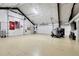 Vast garage space ready for customization or storage with white walls, multiple doors, and ample lighting at 8236 S Ireland Way, Aurora, CO 80016