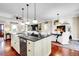Bright kitchen island with stone countertops and views to living and dining areas at 8236 S Ireland Way, Aurora, CO 80016