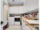 Well-organized laundry room with modern appliances, built-in cabinets, and a butcher block counter at 8236 S Ireland Way, Aurora, CO 80016