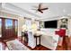 Bright living room with hardwood floors, ample seating, and view of front entrance at 8236 S Ireland Way, Aurora, CO 80016
