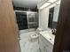 Modern bathroom with contrasting black tile, glass shower doors, and a new vanity at 46 S Nome St, Aurora, CO 80012
