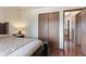 Bedroom with wood floors, closet, and warm lighting at 46 S Nome St, Aurora, CO 80012