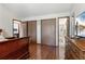 Bedroom with wood floors, ensuite bathroom, closet, and a dresser at 46 S Nome St, Aurora, CO 80012