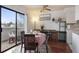 Bright dining area with sliding glass doors to the balcony, adjacent to the kitchen at 46 S Nome St, Aurora, CO 80012