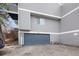Exterior view showcasing attached garage and gray siding, offering both convenience and curb appeal at 46 S Nome St, Aurora, CO 80012