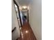 Hallway with hardwood floors and neutral walls leads to various rooms in the home at 46 S Nome St, Aurora, CO 80012