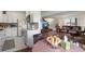 Modern kitchen features white cabinets, stainless steel appliances, and an adjoining dining area at 46 S Nome St, Aurora, CO 80012
