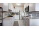 Well-appointed kitchen with white cabinetry, sleek countertops, and updated appliances at 46 S Nome St, Aurora, CO 80012