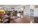 A spacious living room with hardwood floors open to the dining area and kitchen at 46 S Nome St, Aurora, CO 80012