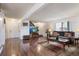 Bright living room with hardwood floors, a plush sofa, and staircase to the upper level at 46 S Nome St, Aurora, CO 80012