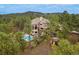 Aerial view of the home surrounded by lush greenery, pool, and multi-level decks at 2521 Juniper Ct, Golden, CO 80401