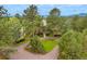 Aerial view of luxury home nestled among mature trees with mountain backdrop at 2521 Juniper Ct, Golden, CO 80401