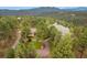 Aerial view of wooded property with home and curved driveway at 2521 Juniper Ct, Golden, CO 80401