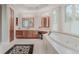 Bright bathroom with soaking tub, tile floors, and double vanity with wood cabinets at 2521 Juniper Ct, Golden, CO 80401