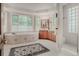 Bright bathroom featuring a soaking tub, walk-in shower, and elegant vanity at 2521 Juniper Ct, Golden, CO 80401