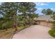 Exterior view of the home highlighting the driveway, multi-level decks, and three-car garage at 2521 Juniper Ct, Golden, CO 80401