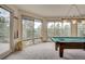 Bright game room featuring a billiard table, large windows with mountain views, and elegant lighting at 2521 Juniper Ct, Golden, CO 80401