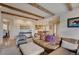 Open-concept living area with wooden beams, hardwood flooring and exposed kitchen at 2521 Juniper Ct, Golden, CO 80401